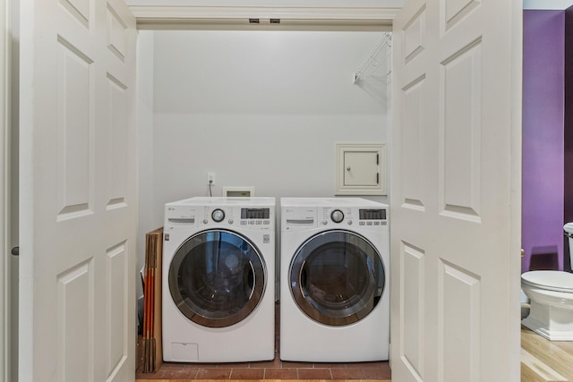 clothes washing area with separate washer and dryer