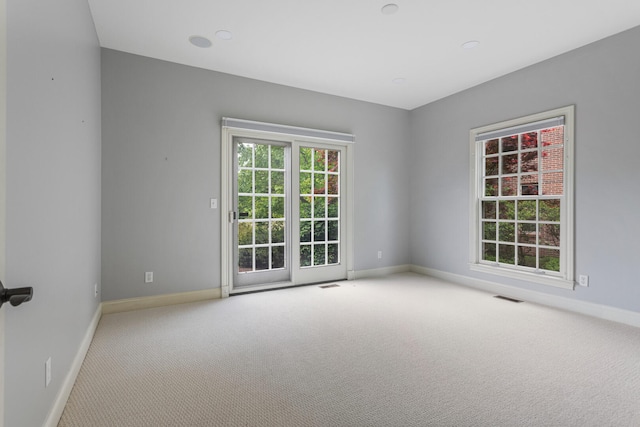spare room with carpet flooring and baseboards