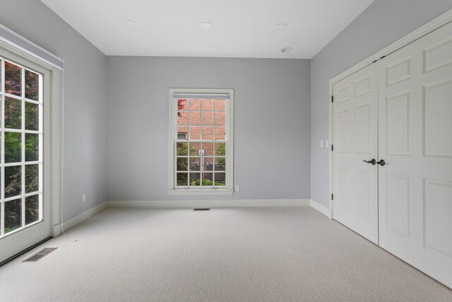 unfurnished bedroom with carpet floors, baseboards, a closet, and recessed lighting