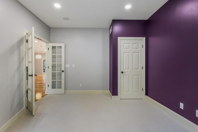 unfurnished bedroom featuring french doors, carpet flooring, baseboards, and recessed lighting