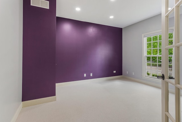 carpeted empty room featuring recessed lighting and baseboards