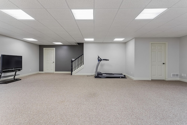 workout room with carpet flooring, baseboards, and a drop ceiling