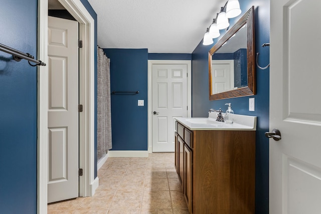 bathroom featuring tile patterned floors, vanity, baseboards, and a shower with shower curtain