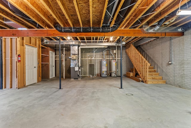 unfinished below grade area with water heater, heating unit, stairs, and brick wall