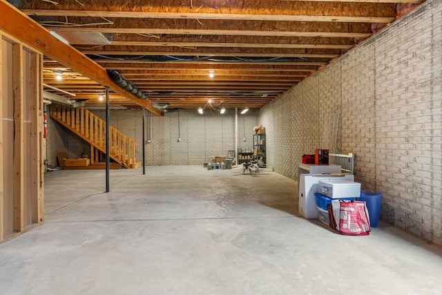 unfinished basement featuring stairway