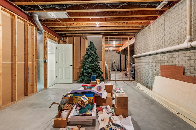 unfinished below grade area featuring brick wall