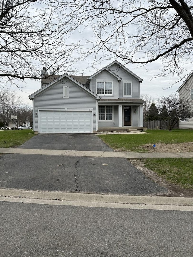 272 Aspen Cir, Gilberts, IL 60136 - traditional home featuring a garage, fence, a front yard, a porch, and driveway