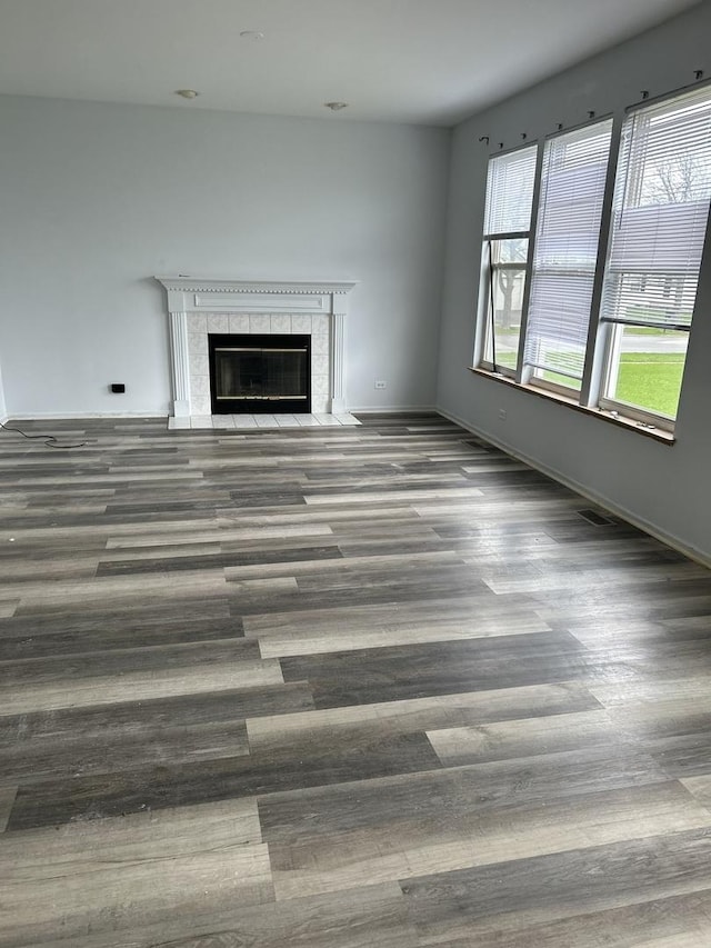 272 Aspen Cir, Gilberts, IL 60136 - unfurnished living room featuring baseboards, a fireplace, and wood finished floors