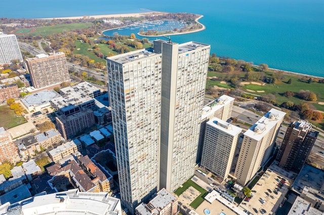 birds eye view of property with a city view and a water view