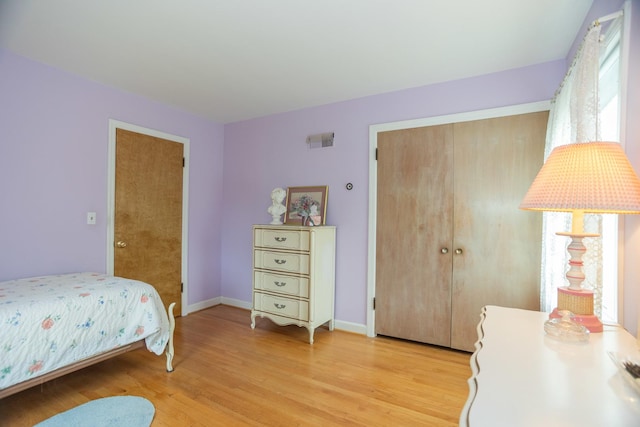 9450 Greenwood Ave, Des Plaines, IL 60016 - bedroom with light wood finished floors, a closet, and baseboards