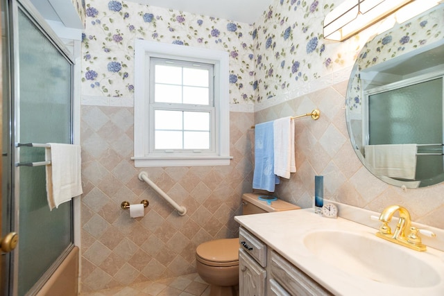 9450 Greenwood Ave, Des Plaines, IL 60016 - full bath with tile walls, wallpapered walls, toilet, vanity, and wainscoting