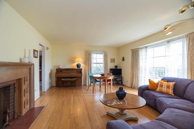 9450 Greenwood Ave, Des Plaines, IL 60016 - living area featuring a brick fireplace and light wood-style flooring