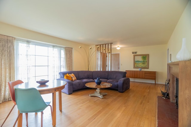 9450 Greenwood Ave, Des Plaines, IL 60016 - living room featuring a fireplace with raised hearth and light wood finished floors