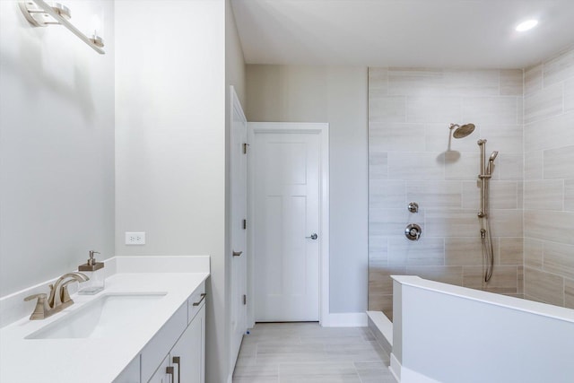 full bathroom featuring vanity, baseboards, walk in shower, and recessed lighting