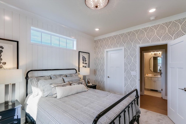 bedroom with recessed lighting, wallpapered walls, and a sink