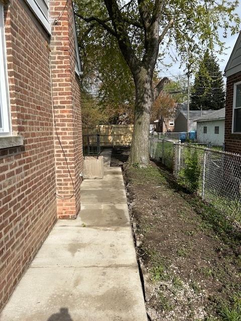 1473 Wentworth Ave, Calumet City, IL 60409 - fenced backyard with driveway and a patio area