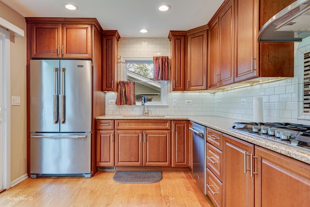 400 Illinois Rd, Frankfort, IL 60423 - kitchen with stainless steel appliances, a sink, exhaust hood, light wood-style floors, and light stone countertops