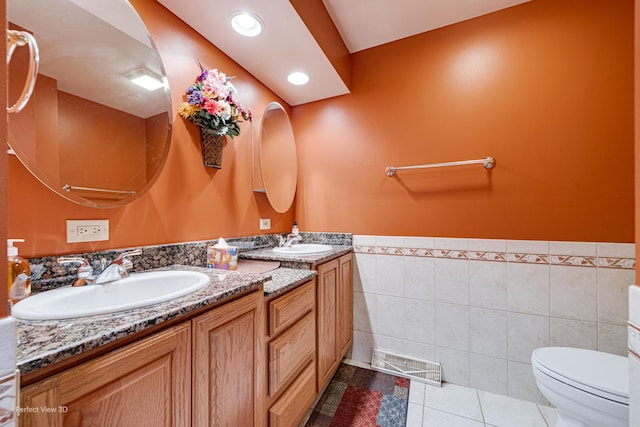 400 Illinois Rd, Frankfort, IL 60423 - bathroom with tile patterned floors, double vanity, toilet, tile walls, and wainscoting