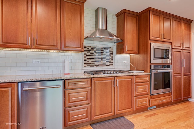 400 Illinois Rd, Frankfort, IL 60423 - kitchen featuring appliances with stainless steel finishes, wall chimney exhaust hood, light wood-type flooring, and brown cabinets