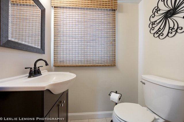 bathroom featuring toilet, vanity, and tile patterned floors