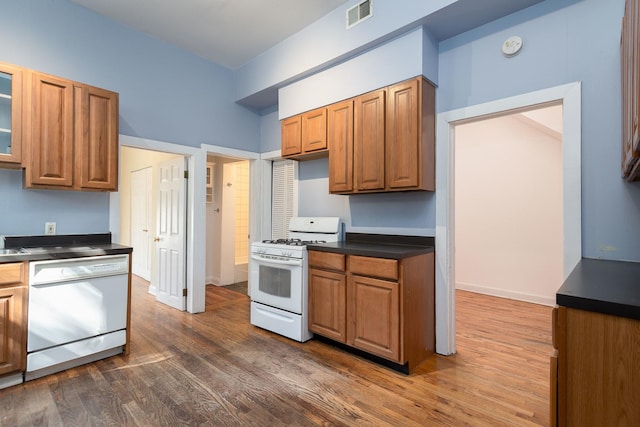 1449 N Artesian Ave, Chicago, IL 60622 - kitchen with dark countertops, brown cabinets, white appliances, and visible vents
