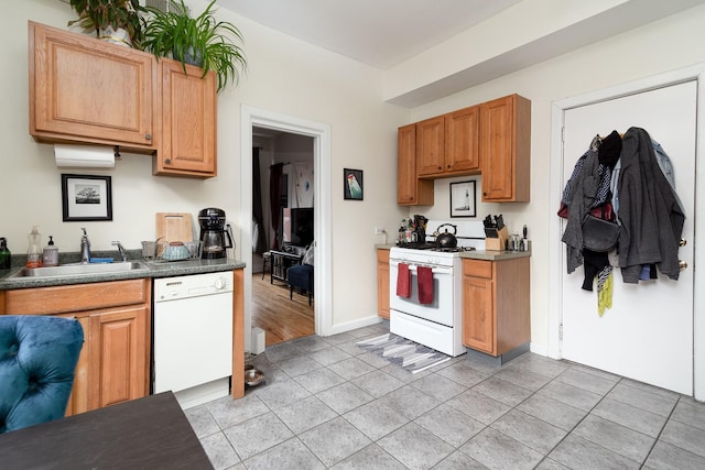 1449 N Artesian Ave, Chicago, IL 60622 - kitchen with dark countertops, a sink, white appliances, baseboards, and light tile patterned floors
