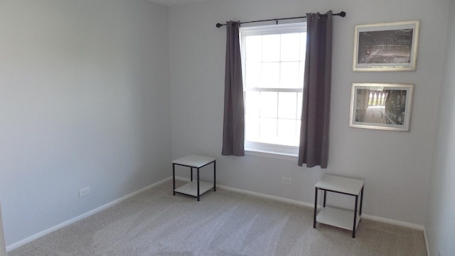 carpeted empty room with plenty of natural light and baseboards