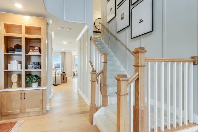 staircase featuring recessed lighting and wood finished floors