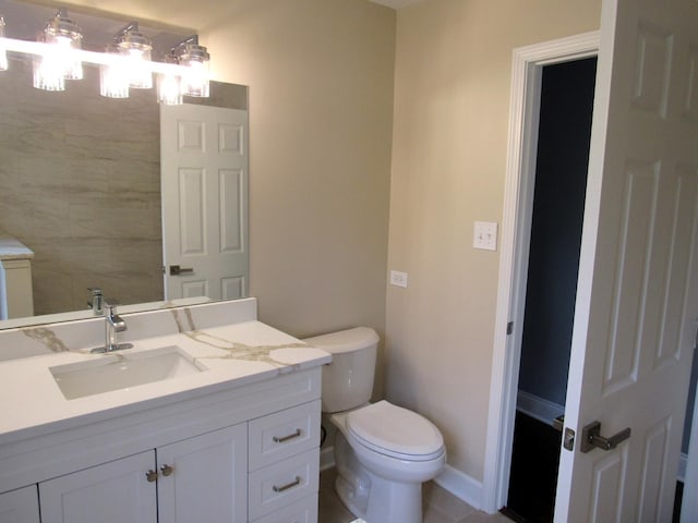 bathroom featuring toilet and vanity