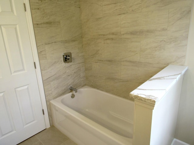 bathroom featuring tile patterned flooring and shower / tub combination