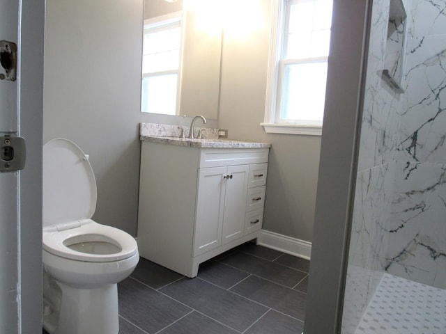 bathroom featuring vanity, a marble finish shower, toilet, and tile patterned floors