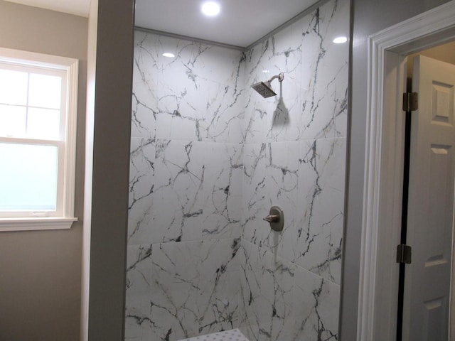 bathroom with a marble finish shower, plenty of natural light, and recessed lighting