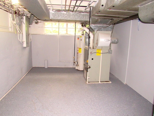 below grade area featuring water heater and heating unit