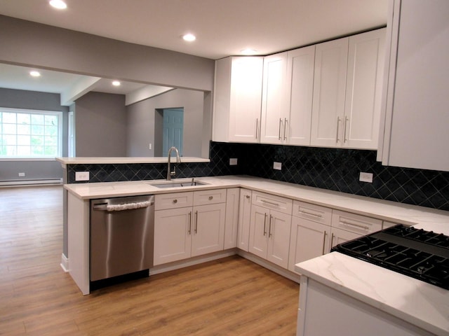 kitchen with dishwasher, a sink, white cabinets, light wood-type flooring, and recessed lighting
