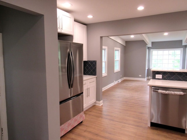 kitchen featuring stainless steel appliances, tasteful backsplash, light wood-style flooring, white cabinetry, and recessed lighting