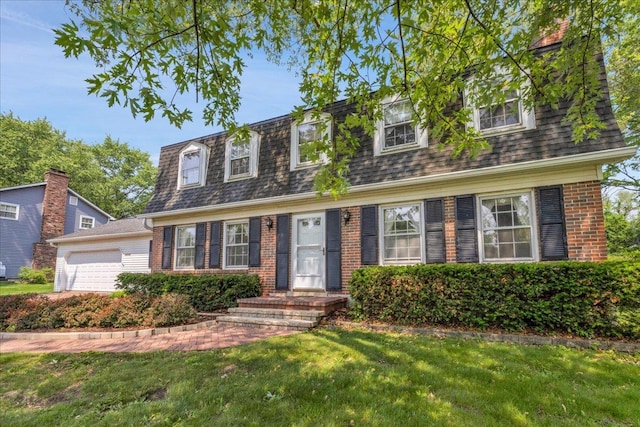 26W266 Tomahawk Dr, Wheaton, IL 60189 - view of front of property featuring a garage, brick siding, a front yard, mansard roof, and a shingled roof