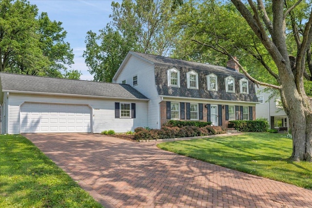 26W266 Tomahawk Dr, Wheaton, IL 60189 - colonial inspired home with a gambrel roof, a chimney, a garage, decorative driveway, and a front yard