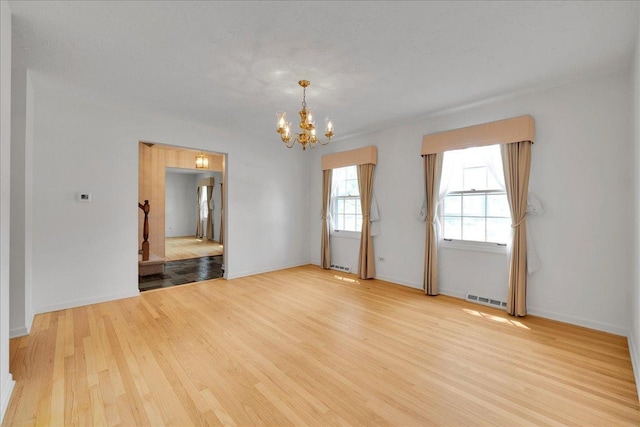 26W266 Tomahawk Dr, Wheaton, IL 60189 - empty room featuring a chandelier and wood finished floors