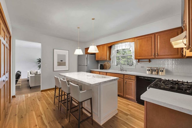 26W266 Tomahawk Dr, Wheaton, IL 60189 - kitchen with freestanding refrigerator, dishwasher, range hood, light wood-style flooring, and a breakfast bar