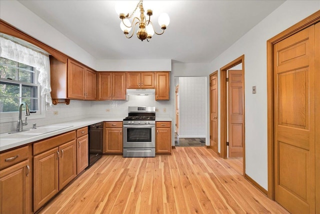 26W266 Tomahawk Dr, Wheaton, IL 60189 - kitchen with stainless steel gas range oven, a sink, black dishwasher, under cabinet range hood, and light wood-style floors