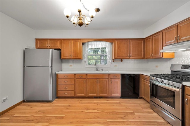 26W266 Tomahawk Dr, Wheaton, IL 60189 - kitchen with freestanding refrigerator, stainless steel gas range, under cabinet range hood, dishwasher, and a chandelier