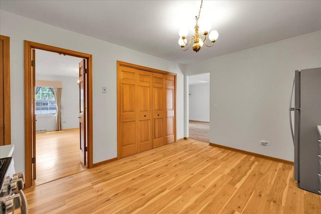 26W266 Tomahawk Dr, Wheaton, IL 60189 - unfurnished dining area with a chandelier, light wood-style floors, and baseboards