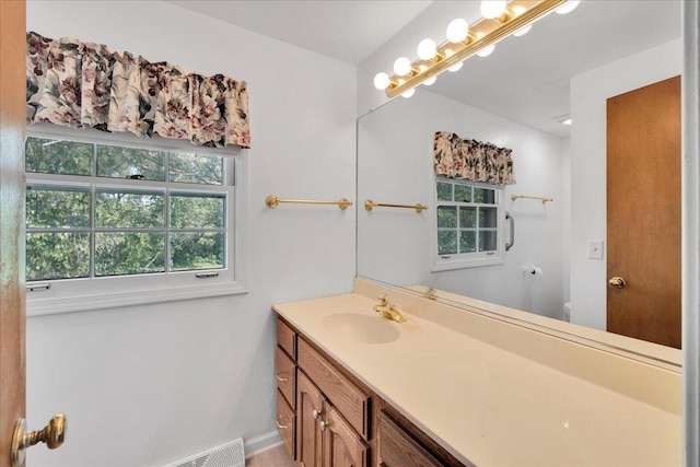 26W266 Tomahawk Dr, Wheaton, IL 60189 - bathroom featuring vanity, toilet, and baseboards