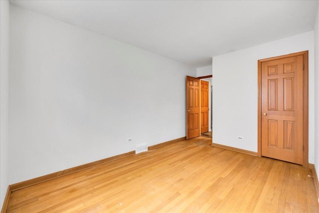 26W266 Tomahawk Dr, Wheaton, IL 60189 - unfurnished bedroom with light wood-style flooring and baseboards
