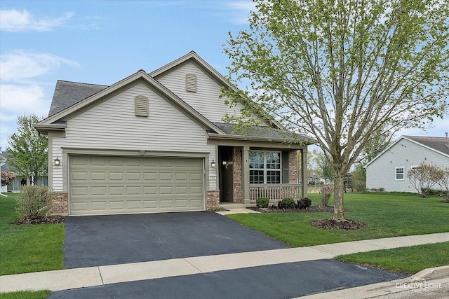 traditional-style home with brick siding, aphalt driveway, a front yard, and a porch