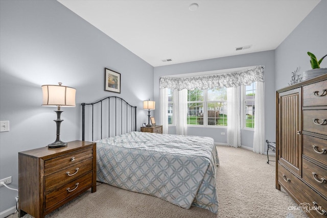 bedroom with light colored carpet, baseboards, and visible vents