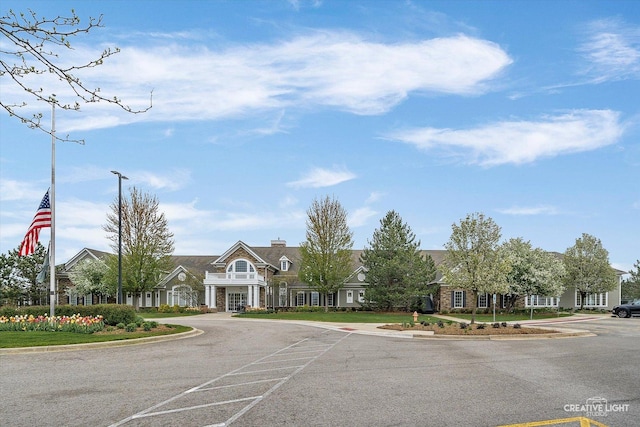 view of property featuring uncovered parking and a residential view