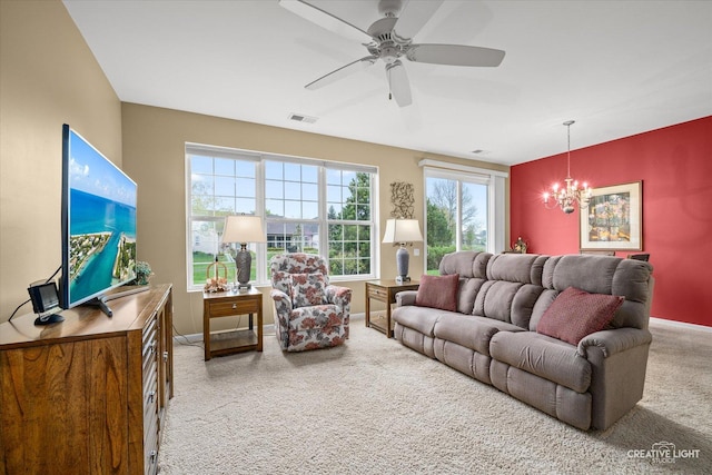 living area with baseboards, carpet, ceiling fan with notable chandelier, and visible vents
