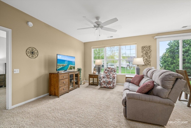 carpeted living area with baseboards, visible vents, and ceiling fan
