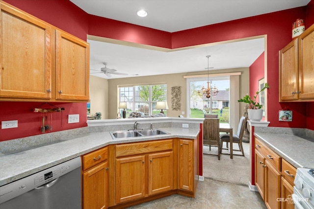kitchen featuring a sink, light countertops, ceiling fan with notable chandelier, a peninsula, and stainless steel dishwasher